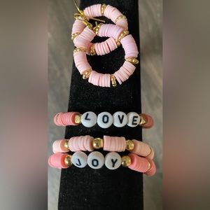 Bracelet set of three, with a pair of earrings. Pink and gold themed.
